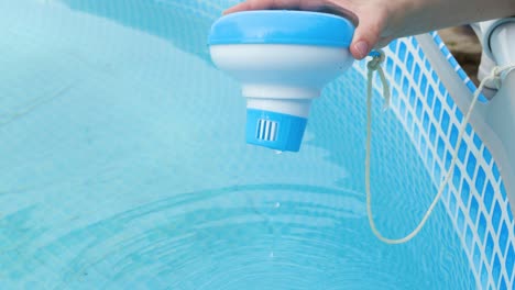 worker hands isinfection and chlorination of water in the pool. purification from pollution pool chlor dispenser