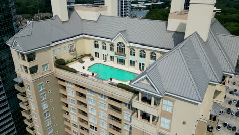 high angle view of swimming pool of rooftop terrace of multistorey apartment building or hotel