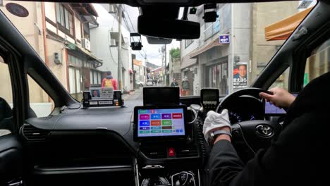 navigating a car through kyoto's narrow streets