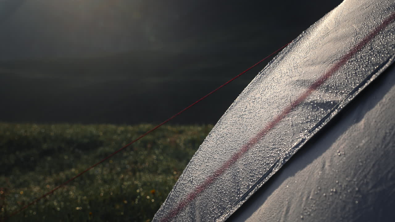 Dew-covered tent in the mountains