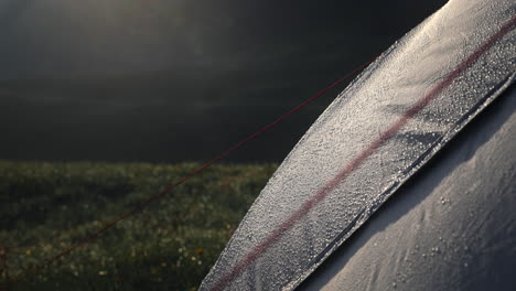 dew-covered tent in the mountains