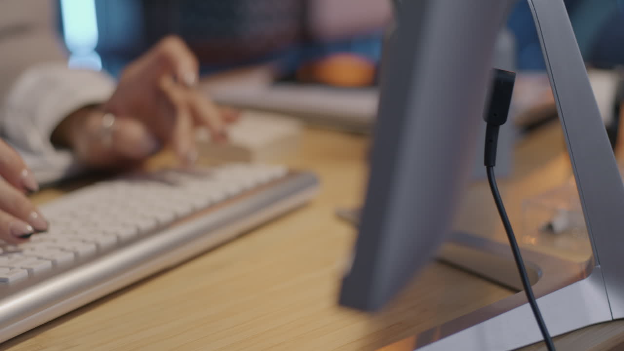 Woman Typing on Keyboard at a Desk
