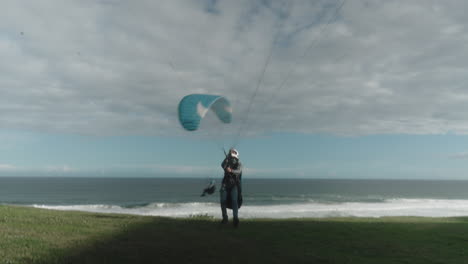 paraglider preparing his kite for flight