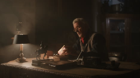 older passionate man evaluates an old porcelain box