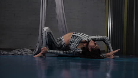Acrobatic manual side bend twists at fitness studio