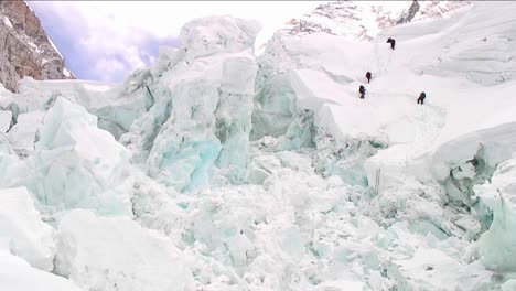 climbers dwarfed by ice formations