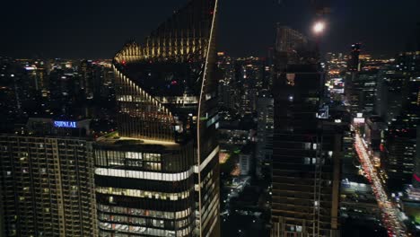 夜にバンコクの高層ビルを飛行