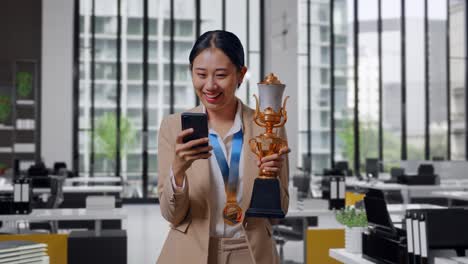Woman Celebrating Achievement in Modern Office