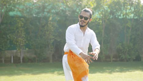 Indian-man-doing-Bhangra-dance-in-a-park