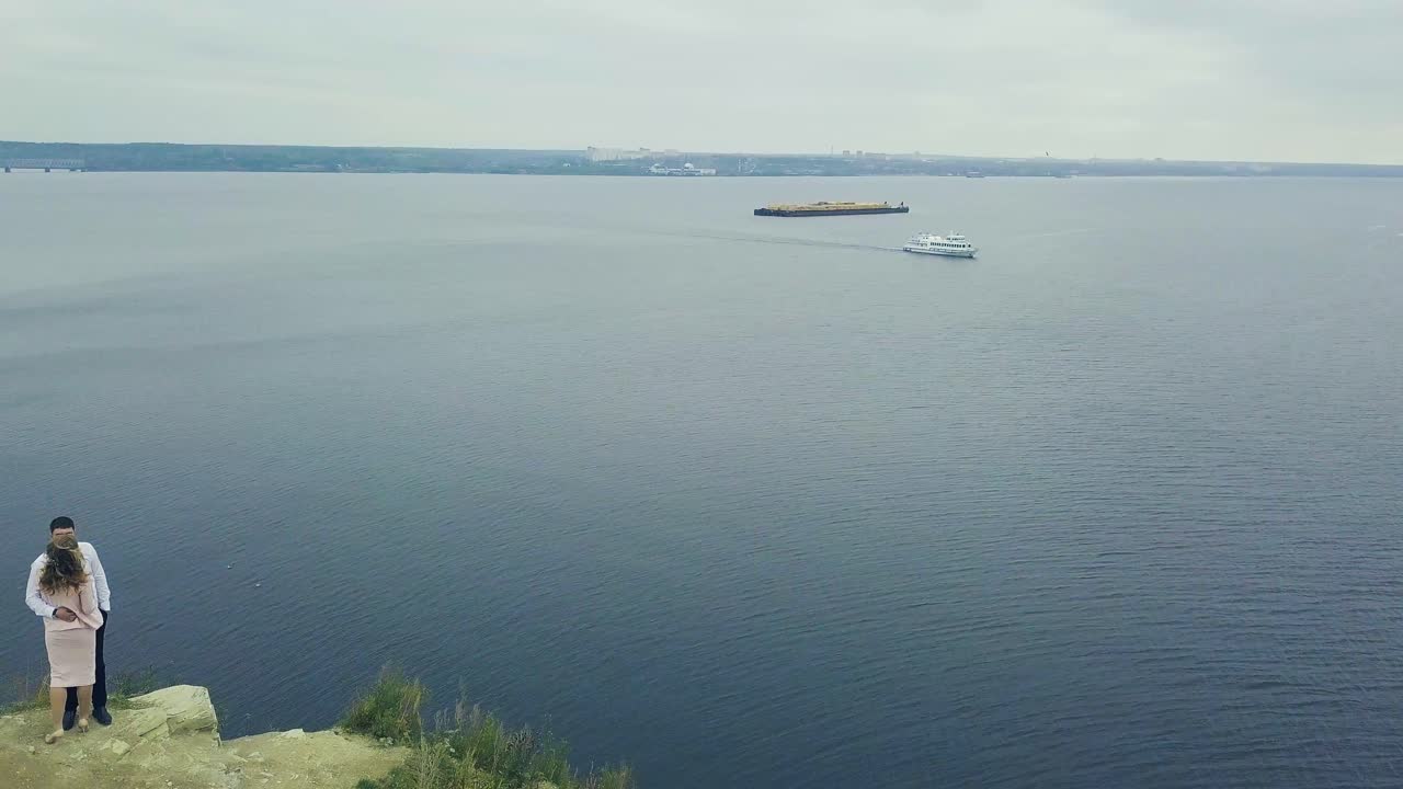 강 을 내려다보는 절벽 에 있는 부부