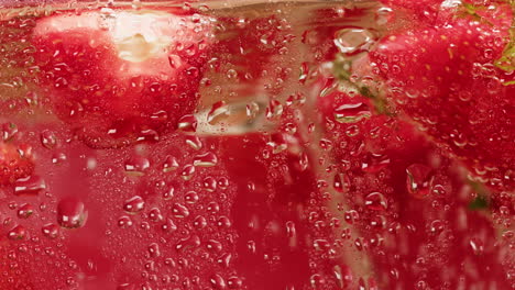 close-up of strawberries in a glass with water drops