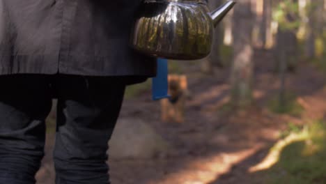 Metal-shiny-tea-pot-with-reflection-of-the-forest-and-autumn-slow-motion-atmosphere