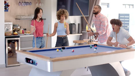 playing pool and enjoying drinks, diverse friends hanging out in modern living room
