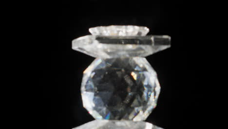 glass jewel rotating and shining on light abstract overlay effects on black