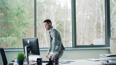 happy businessman dancing in office