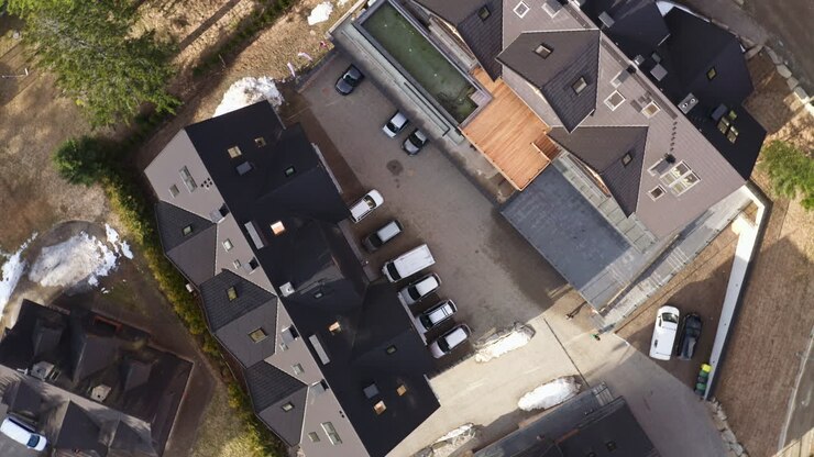 Bird's Eye View Over Roofs Of Hotels And Parking Area In Jaszczurówka, Zakopane, Poland - Drone Orbiting