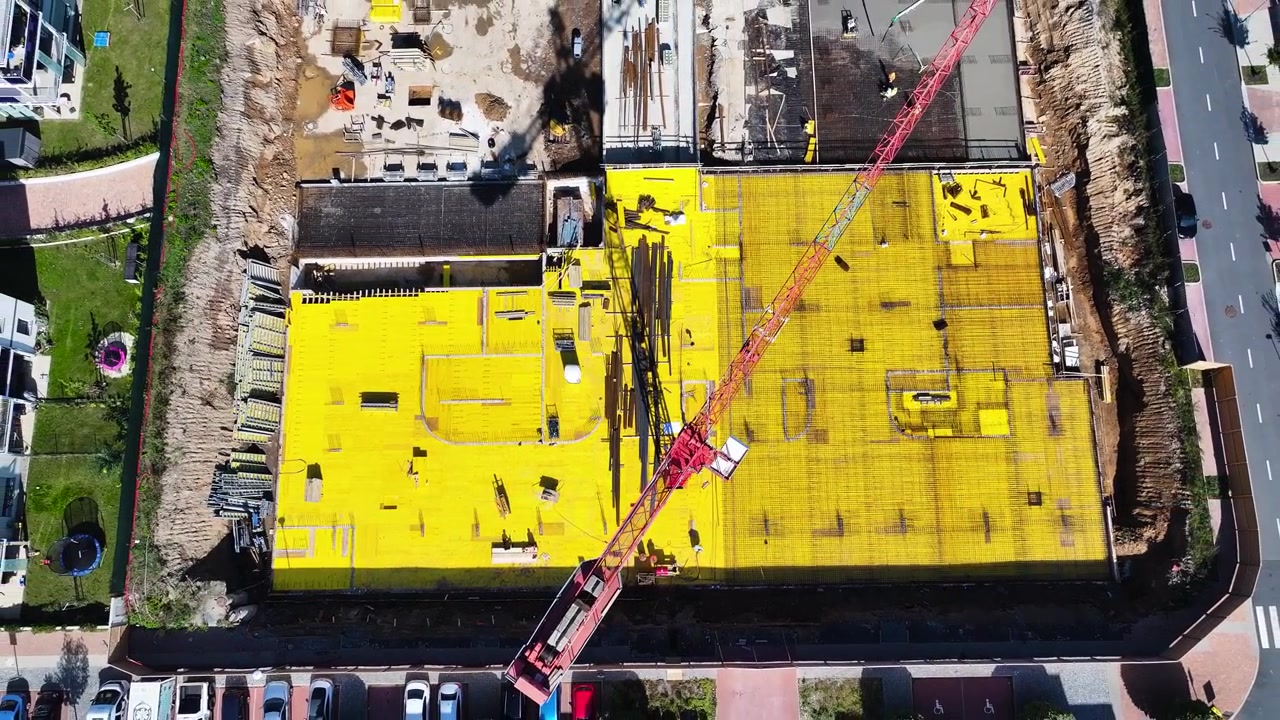 Aerial ascend over yellow foundation layer at construction site, Czechia