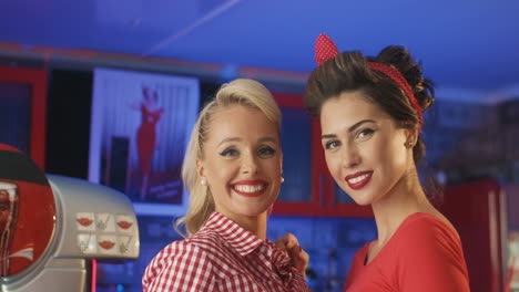 cute pin ups blowing kisses and smiling in an american diner