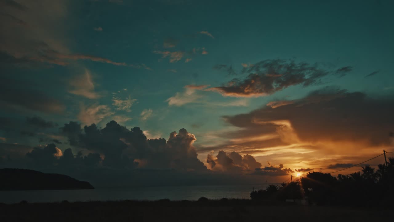 Colorful sunset time lapse with colored clouds rolling over a Greek summer sea
