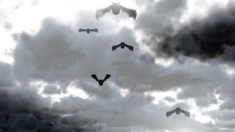 halloween bats flying with cloudy sky