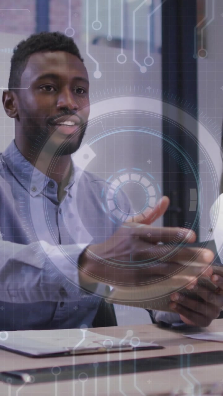 Business meeting with digital data processing animation over diverse colleagues