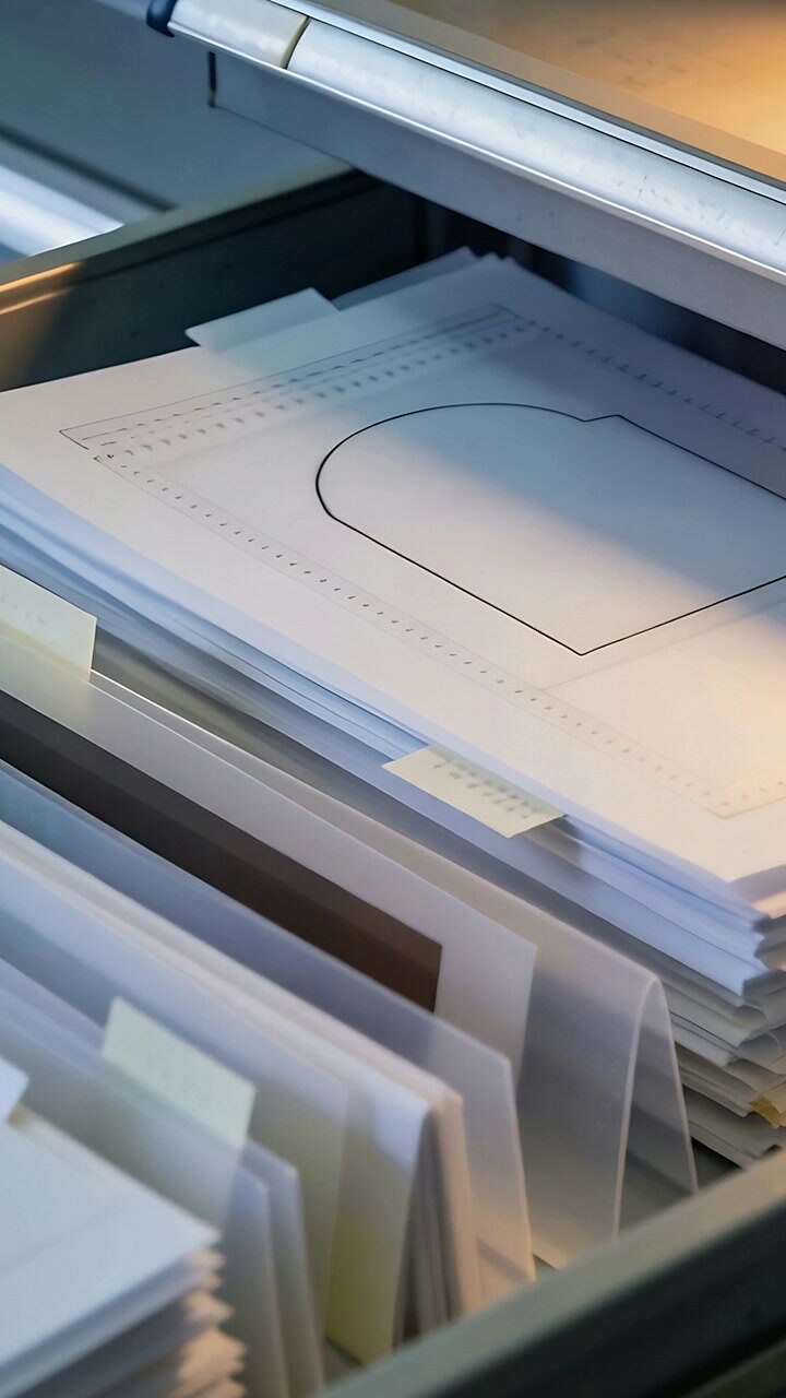 Vertical video: Moving camera closer, inspecting heart prints in metal drawer revealing tab