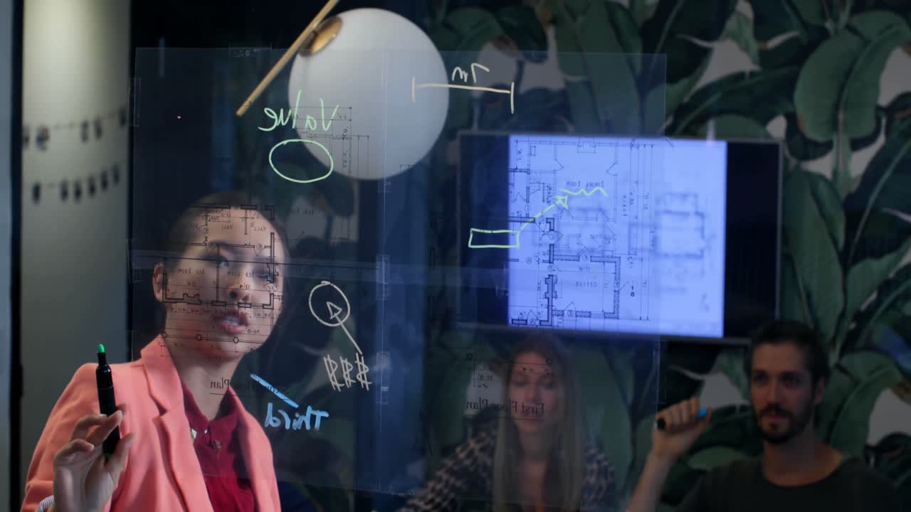 Businesswoman discussing over glass board in office 4k