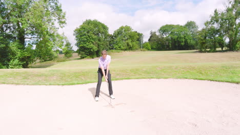 male golf player playing golf and knocking golf ball out on golf course, copy space