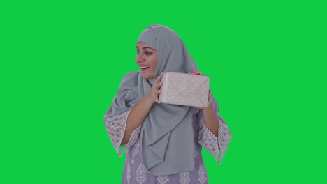 muslim woman receiving a gift green screen