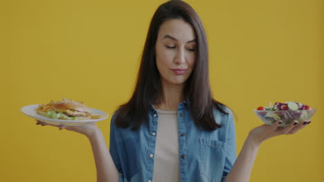 woman choosing between healthy and unhealthy food options