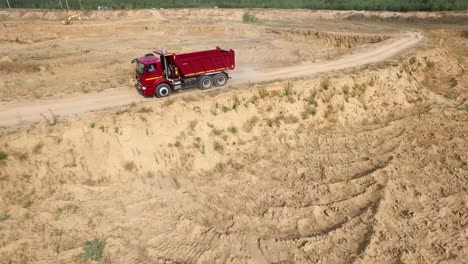 red dump truck in a sand quarry