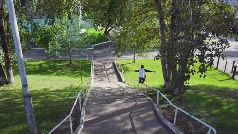 man skateboarding down stairs in park