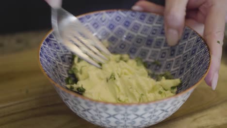 Closeup-of-a-chef-making-garlic-herb-butter-in-a-bowl