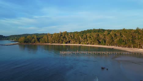 Stunning-aerial-top-view-flight-natural-beach-bay-thailand,-Wooden-walkway-pier-golden-hour,-lagoon-koh-kood-2022