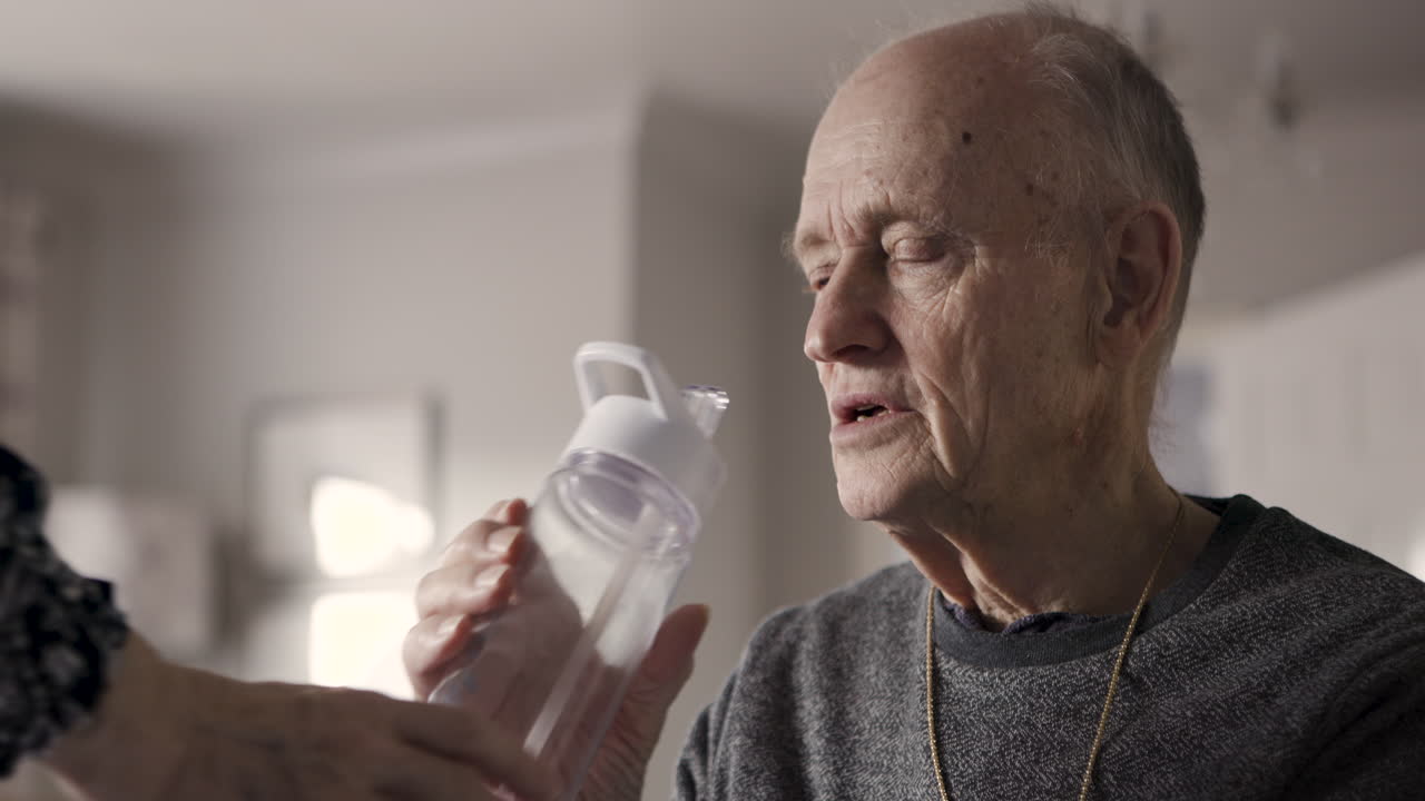 Elderly man with water bottle