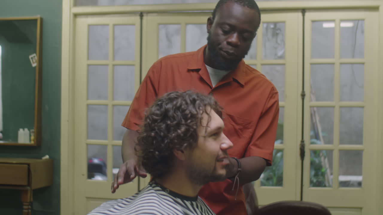 Client Explaining Desired Haircut to Black Barber