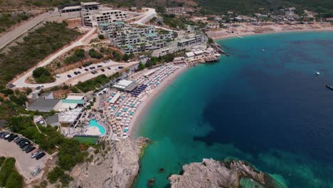 Albanian-Riviera-seaside-vacations-resorts,-blue-turquoise-sea-water-washing-cliffs-and-pebbles-beaches