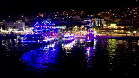 colorful lights on tourist ship and neon-lit pier radiance reflecting on saranda tranquil mediterranean sea bay – a perfect summer holiday scene