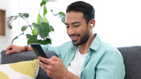 Man,-social-media-and-phone-with-earphones-at-home