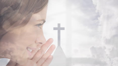 smiling woman with church cross silhouette against cloudy sky background