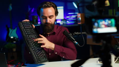 tech expert testing headphones, mouse and keyboard, reviewing them