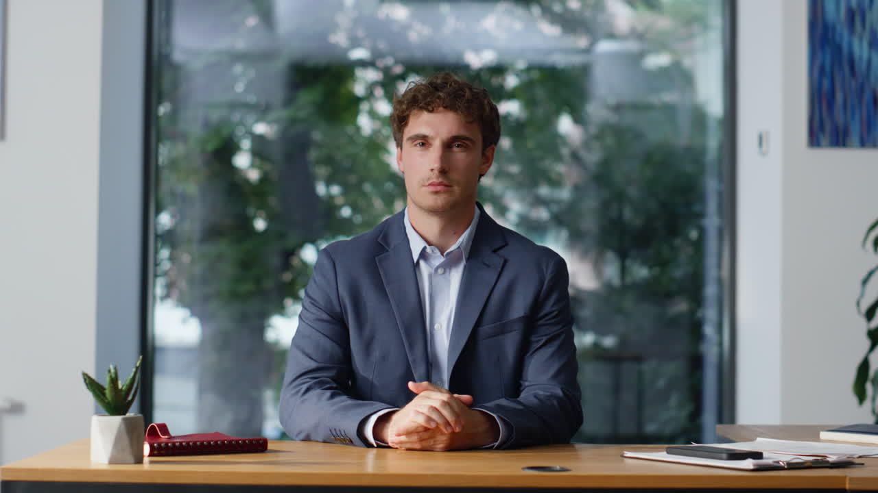 Formal suit manager posing office with big window closeup. Ceo looking camera