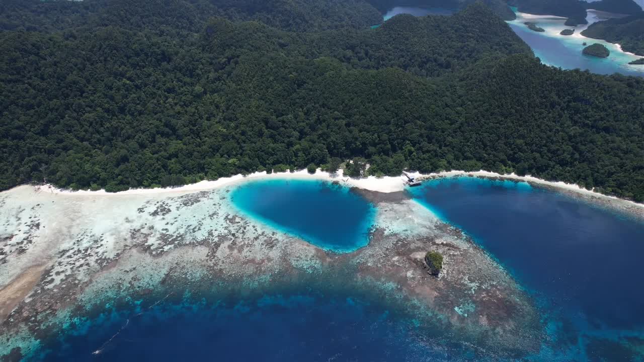 View on white sandy beautiful lagoons, island formations and reefs in Raja Ampat, Wayag, Indonesia