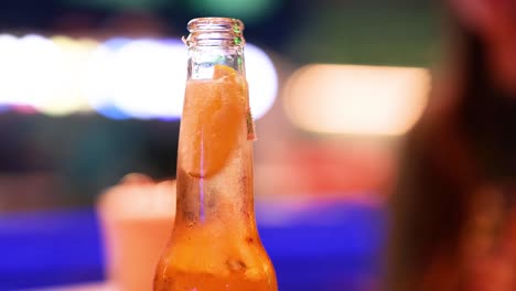 close-up of beer bottle in vibrant setting