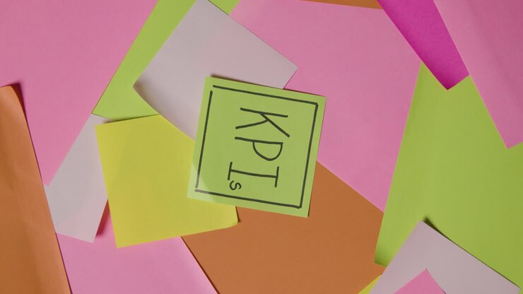 Business Concept Of Revolving Sticky Notes With KPI Written On Top Note