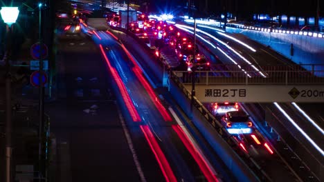 a night timelapse of the traffic jam at the city street in tokyo long shot