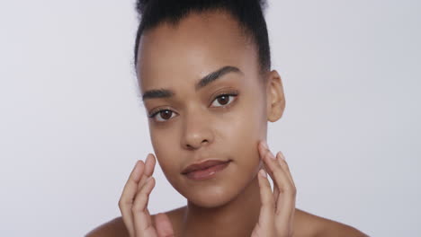 portrait beautiful african american woman touching face with hands caressing smooth healthy skin complexion enjoying perfect natural beauty on white background