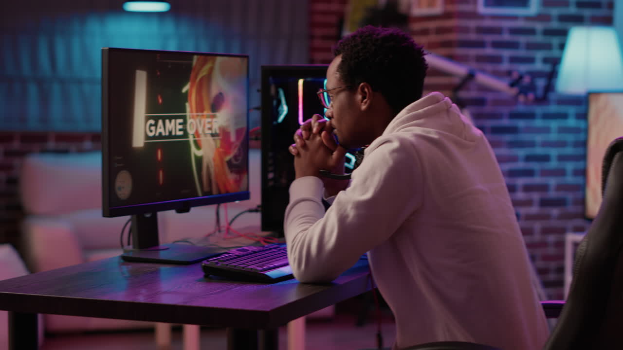 Handheld shot of gamer streaming multiplayer first person shooter angry after losing online tournament