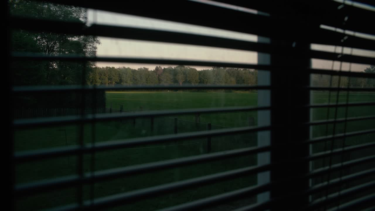 창문에 있는 블라인드들 사이에서 찍은 사진