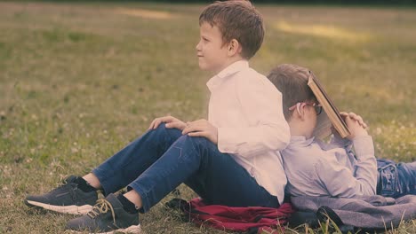 nice boy wearing school uniform leans on sleeping friend